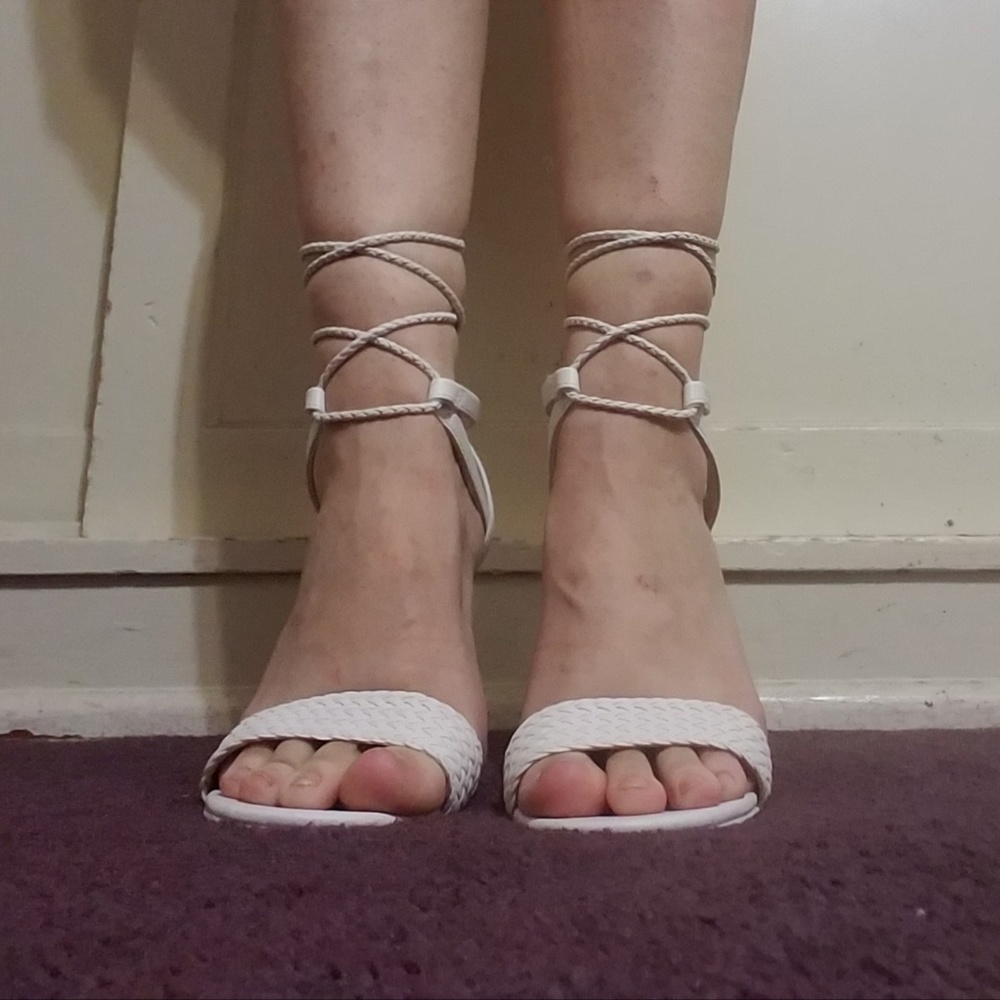 White, mirrored block heels with lace up straps.